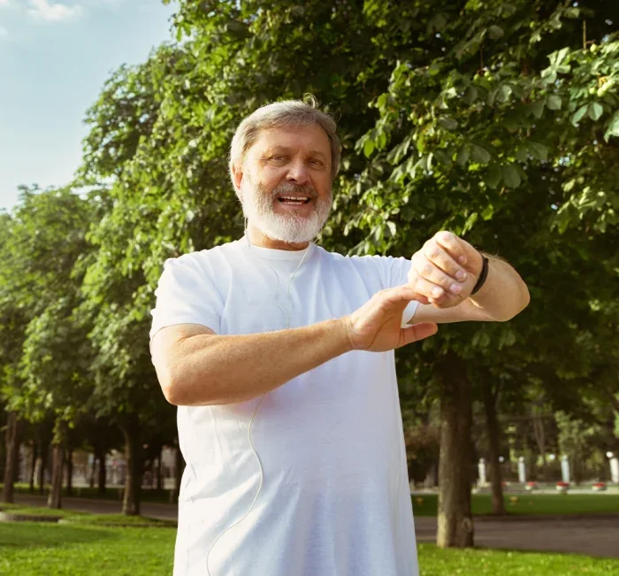 A man outdoors in a park as part of a daily wellness routine